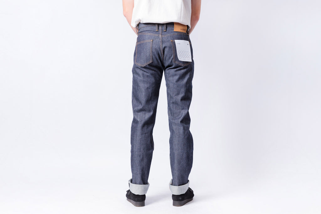 Person wearing blue jeans on a white background