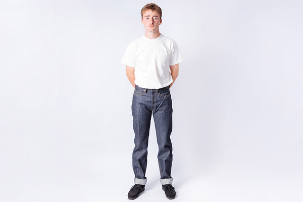 Person wearing a white t-shirt and blue jeans on a white background