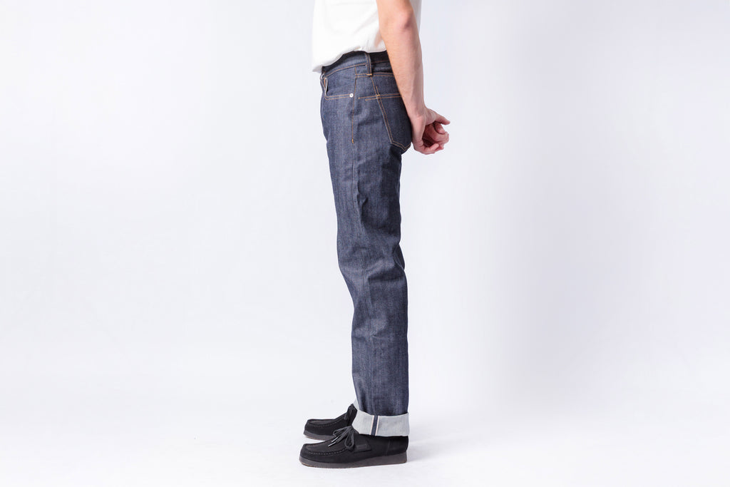 Person wearing blue jeans on a white background