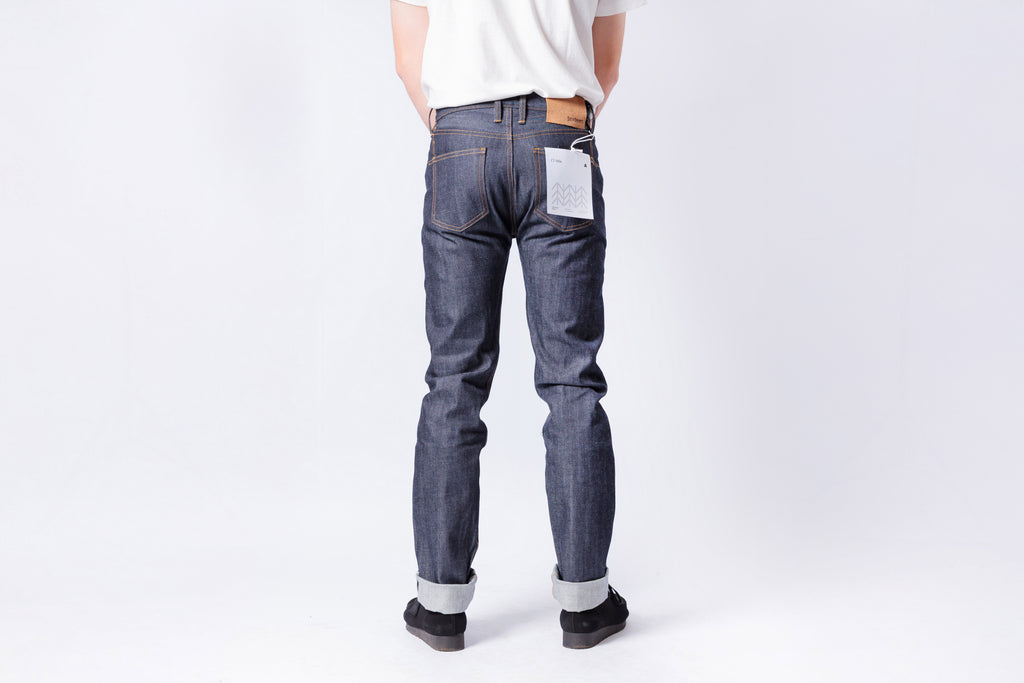 Person wearing blue jeans on a white background