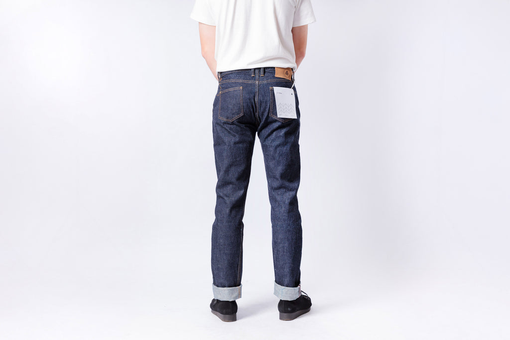 Person wearing blue jeans and a white shirt on a white background