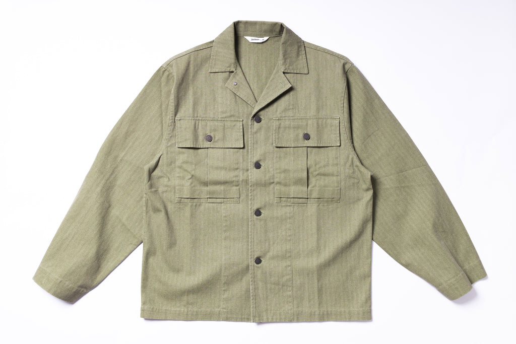 Green jacket with multiple pockets on a white background