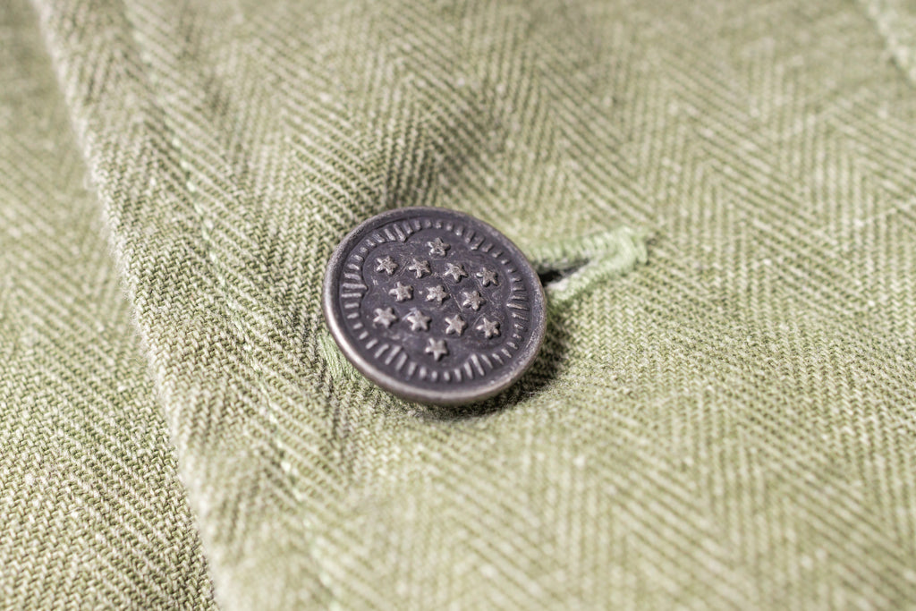 Close-up of a button on a textured fabric surface