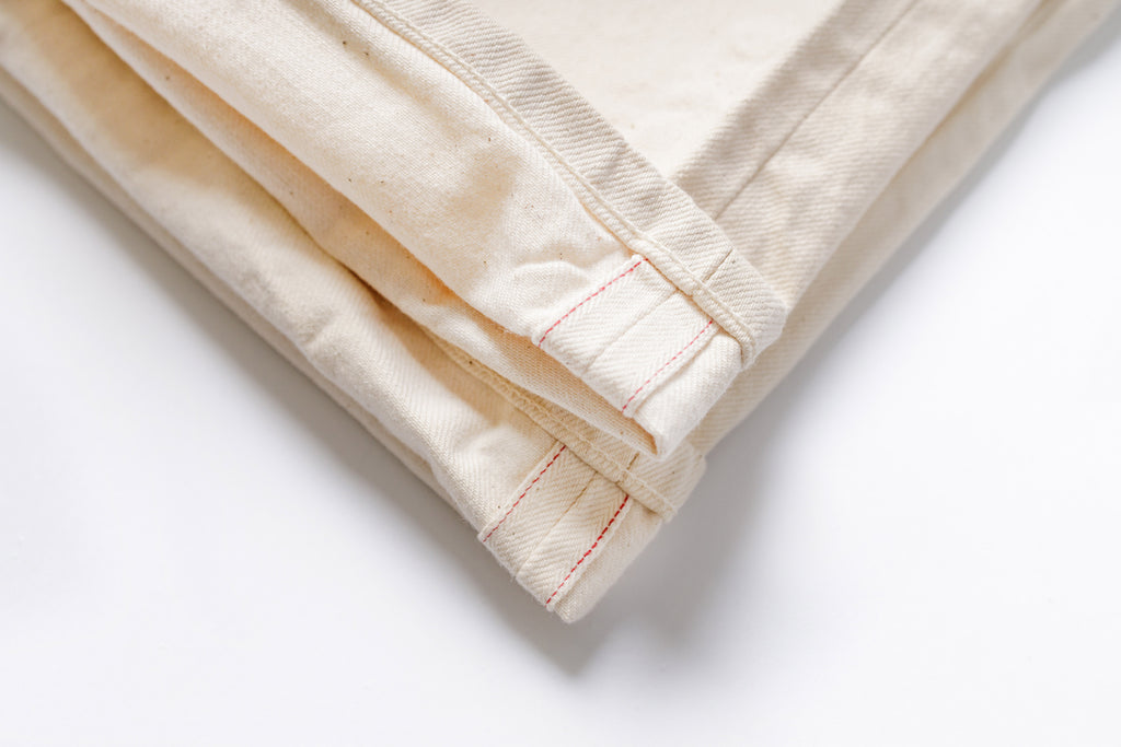 Folded beige fabric on a white background