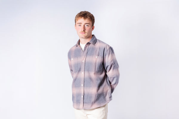 Man wearing a plaid shirt against a white background