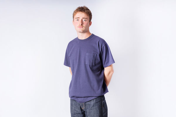 Person wearing a Navy t-shirt on a white background