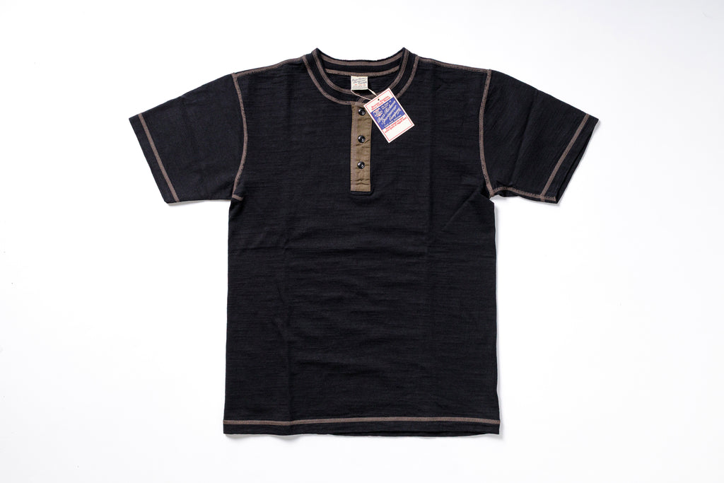 Black short-sleeve shirt with a tag on a white background