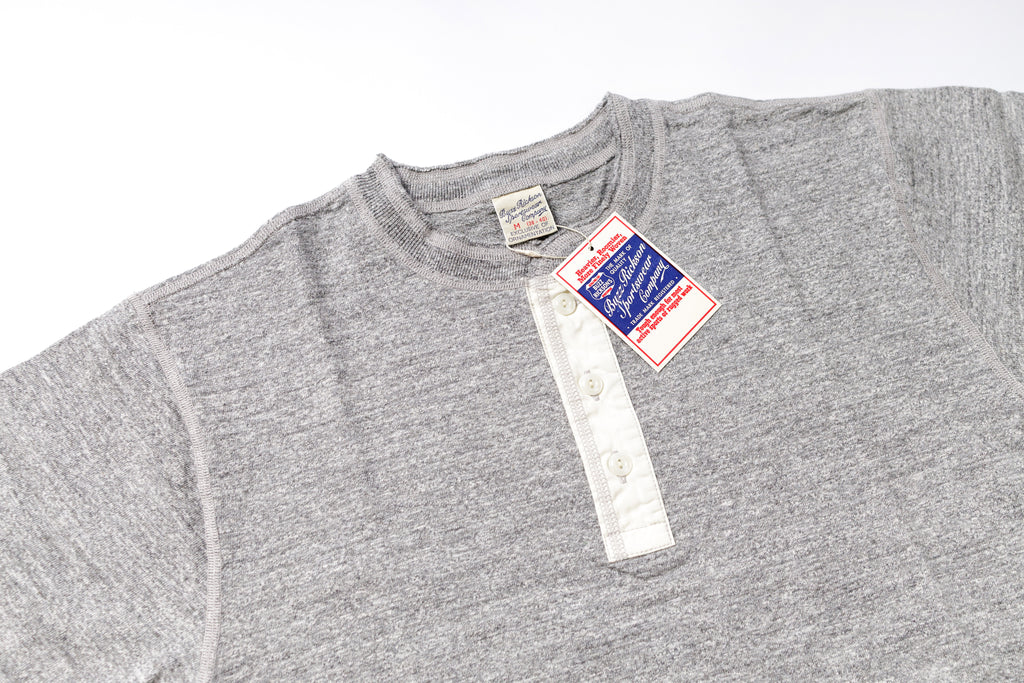 Gray t-shirt with a tag on a white background