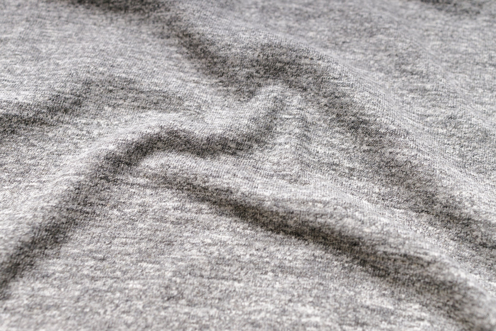 Close-up of a textured gray surface with a logo.