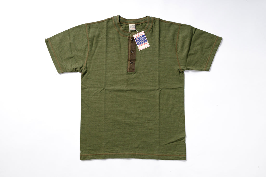 Green t-shirt with a tag on a white background