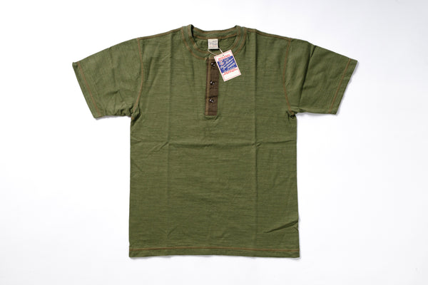 Green t-shirt with a tag on a white background