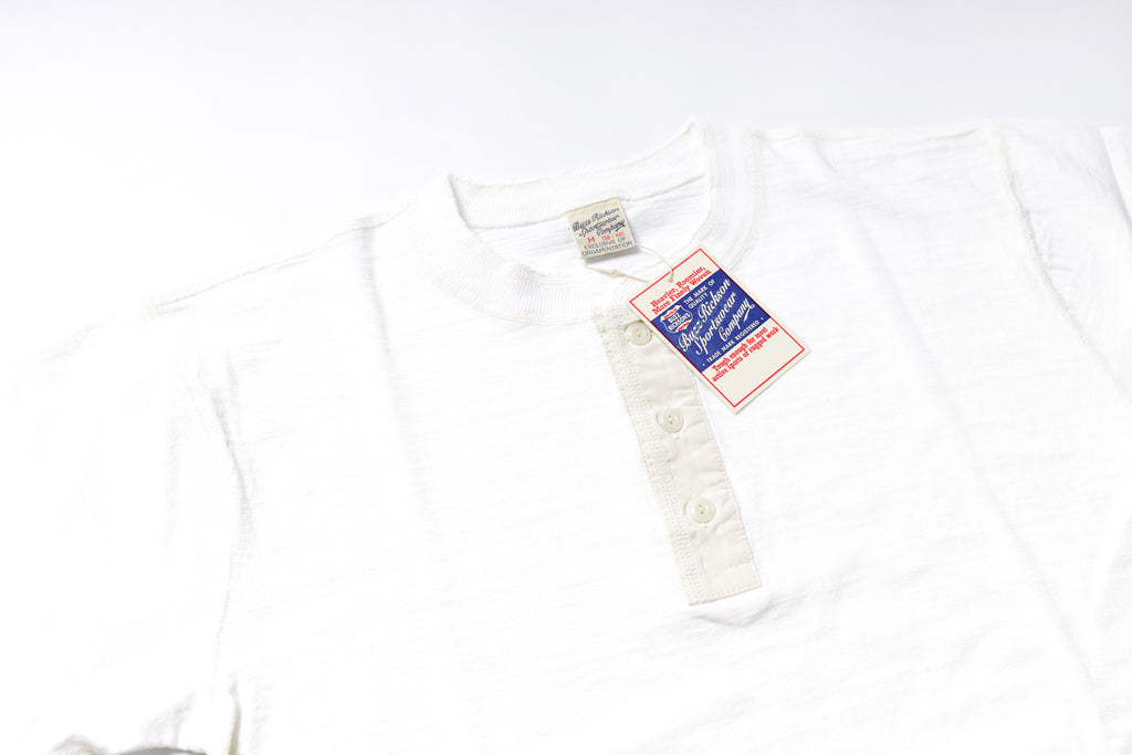 White shirt with a tag on a white background