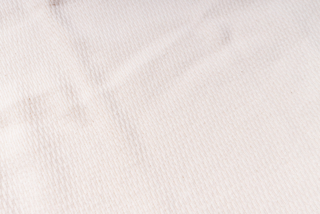 Close-up of a textured white fabric surface