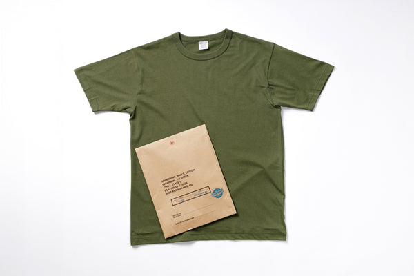 Green t-shirt with a cardboard box on a white background
