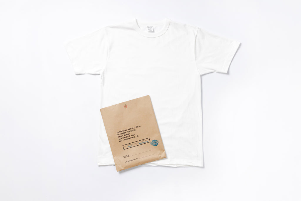 White t-shirt with a brown paper bag on a white background