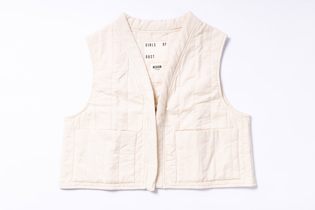 White quilted vest with text on a white background