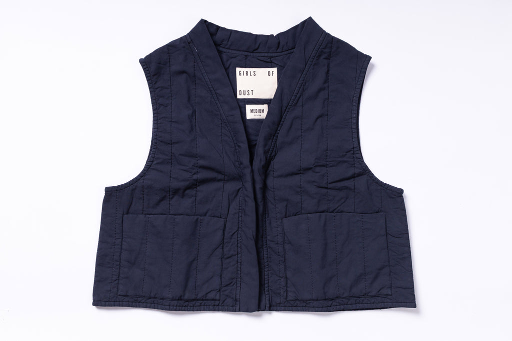 Navy blue vest with a brand label on a white background