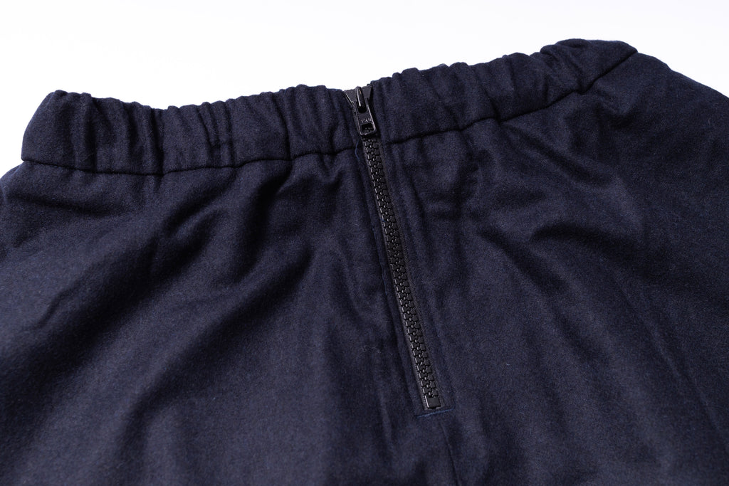 Close-up of navy blue pants with a zipper on a white background