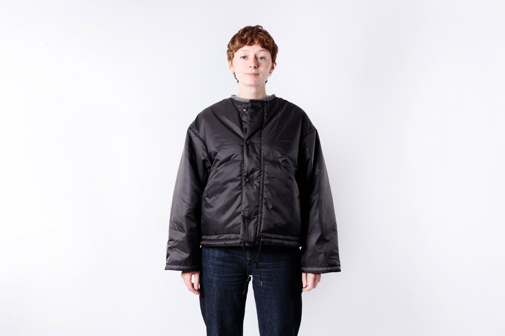 Person wearing a black jacket on a white background