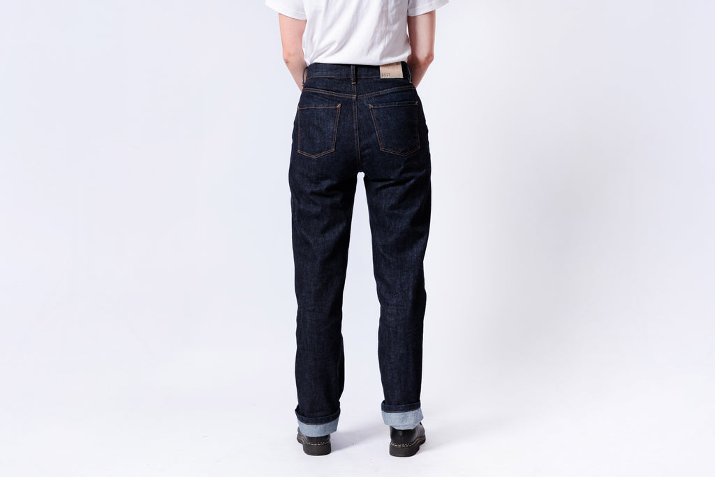 Person wearing dark blue jeans and a white shirt on a white background