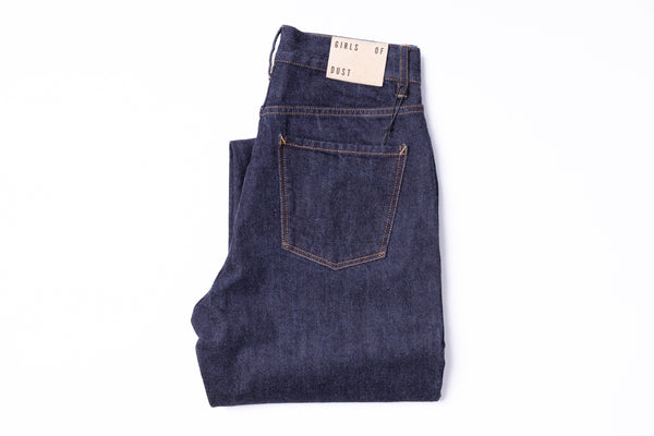 Folded pair of jeans with a brand tag on a white background