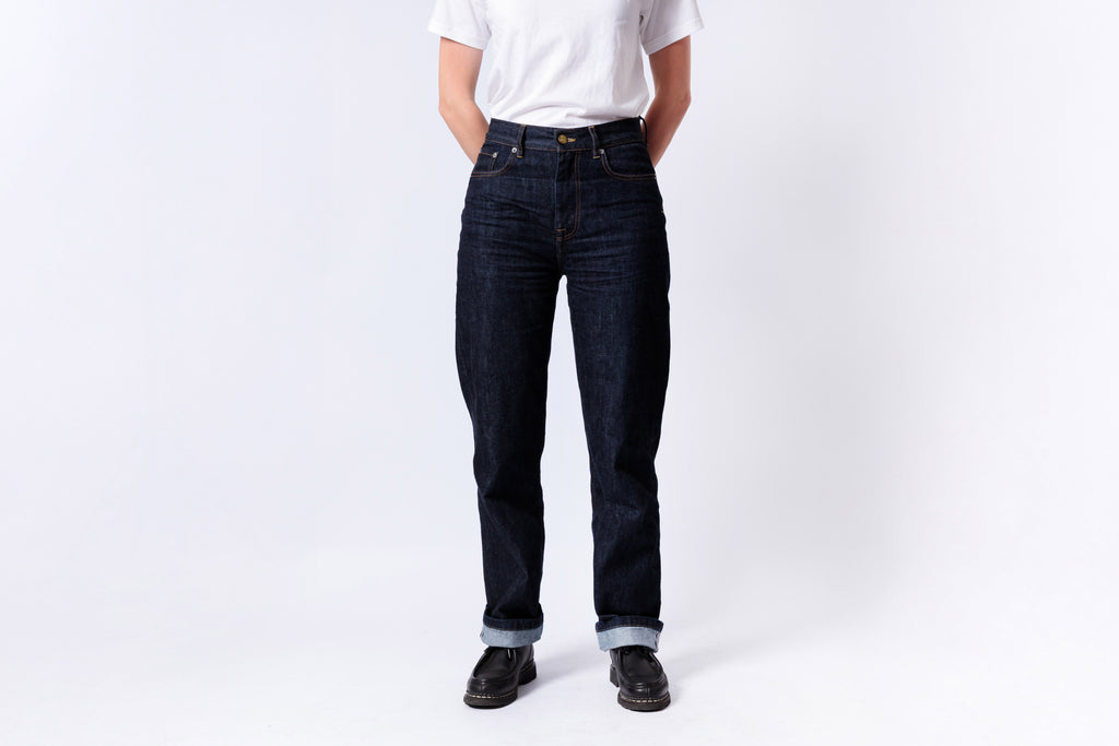 Person wearing dark blue jeans and a white shirt on a white background