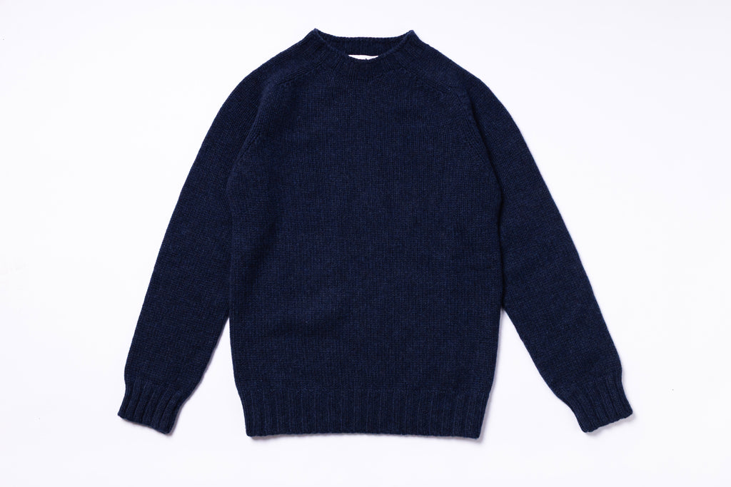 Navy blue sweater on a white background