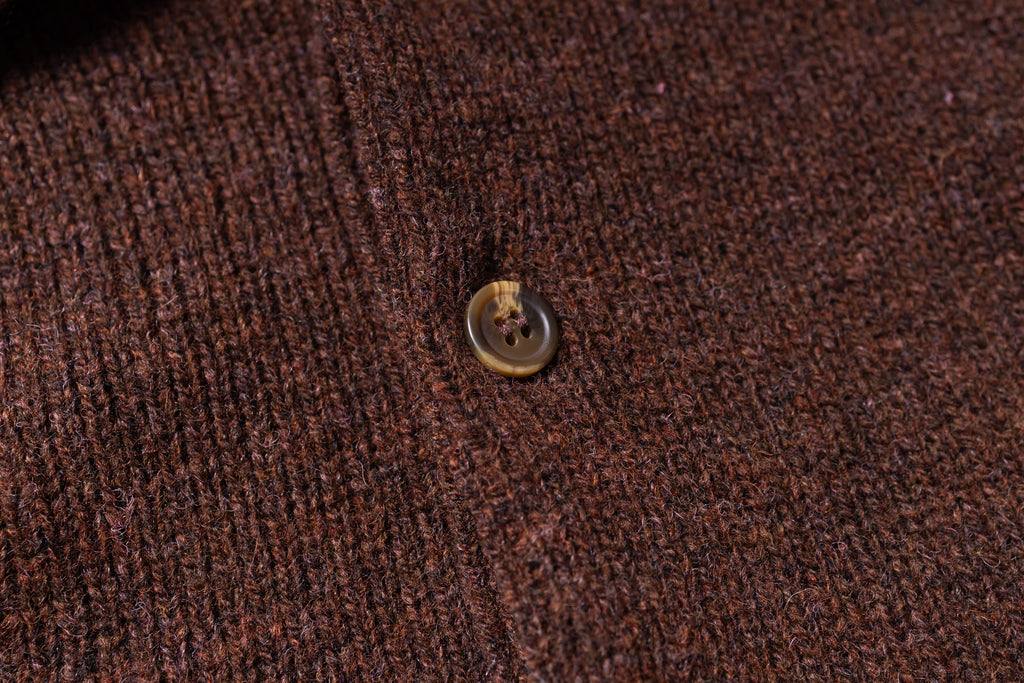 Close-up of a button on brown fabric