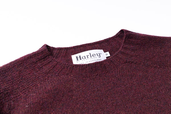 Maroon sweater with a Harley label on a white background