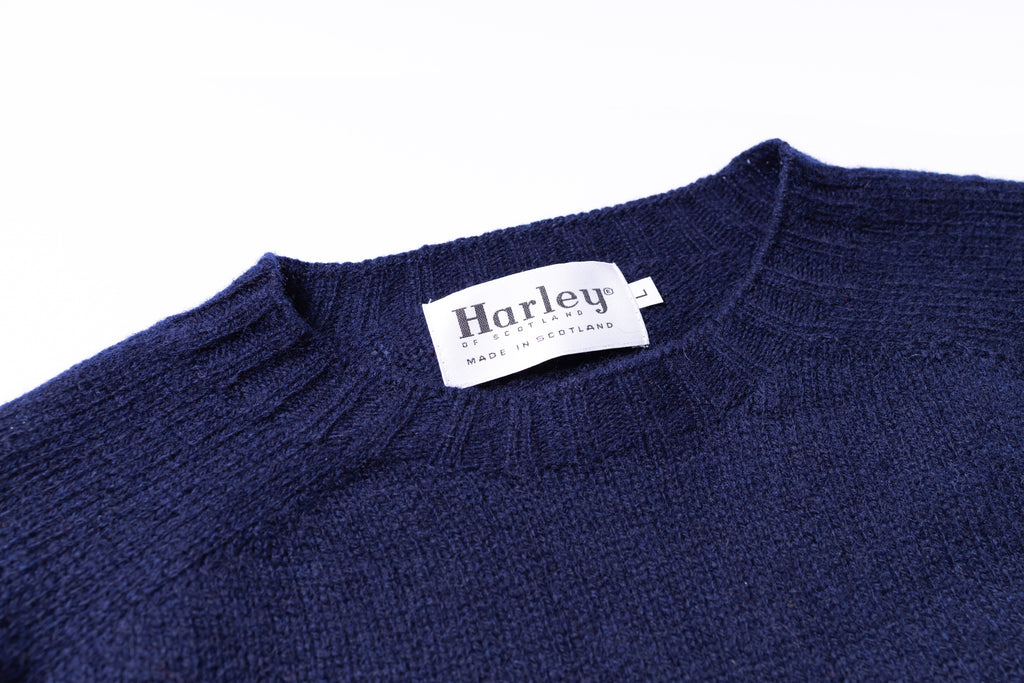 Navy blue sweater with a Harley label on a white background