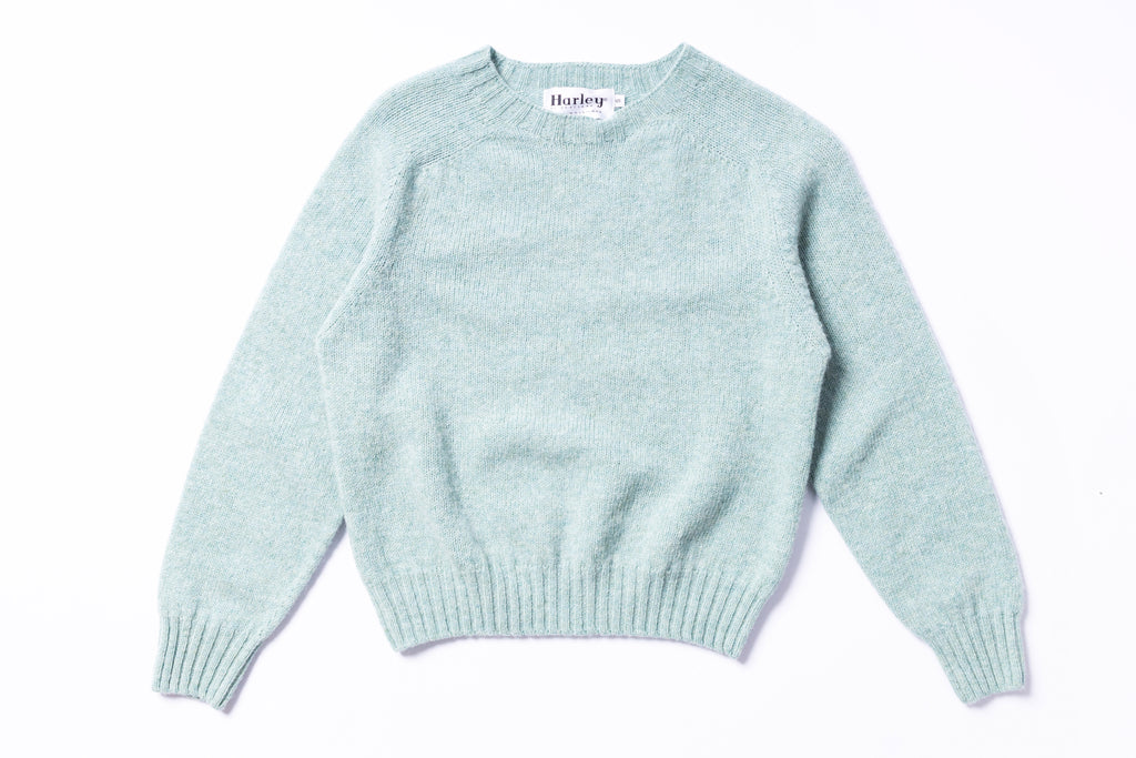 Light blue sweater with 'Harley' label on a white background