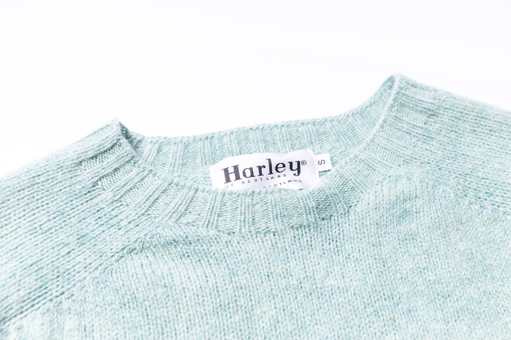 Light blue sweater with a Harley label on a white background