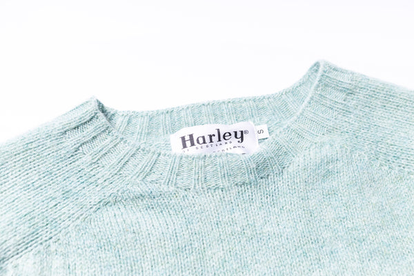 Light blue sweater with a Harley label on a white background