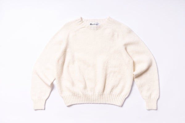 White sweater with brand logo on a white background