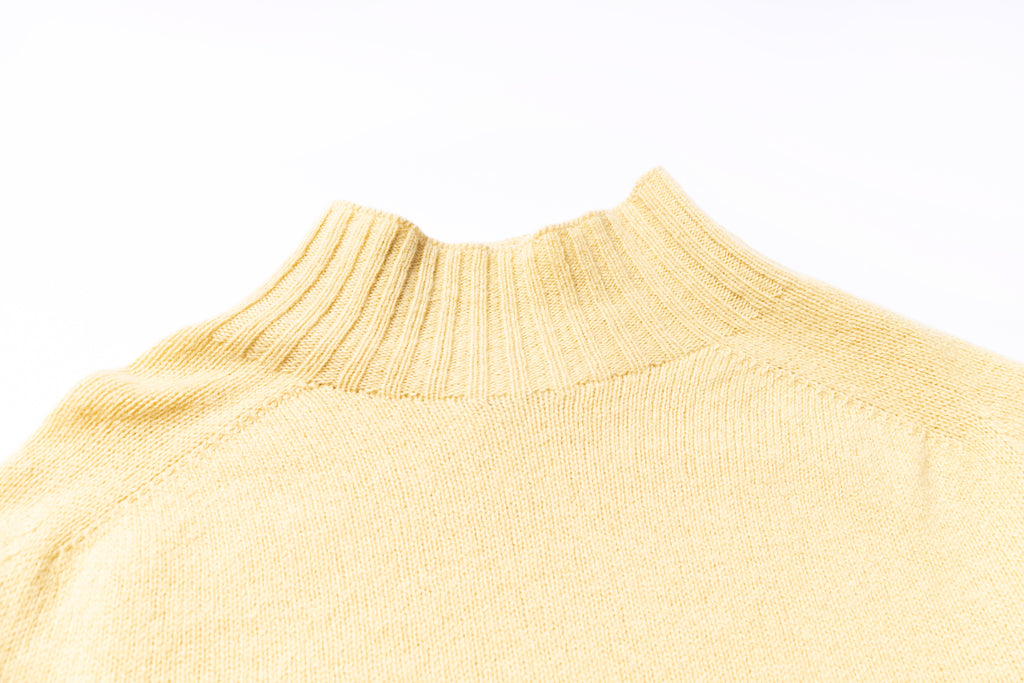 Close-up of a beige sweater collar on a white background
