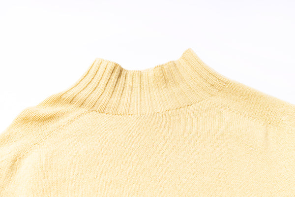 Close-up of a beige sweater collar on a white background