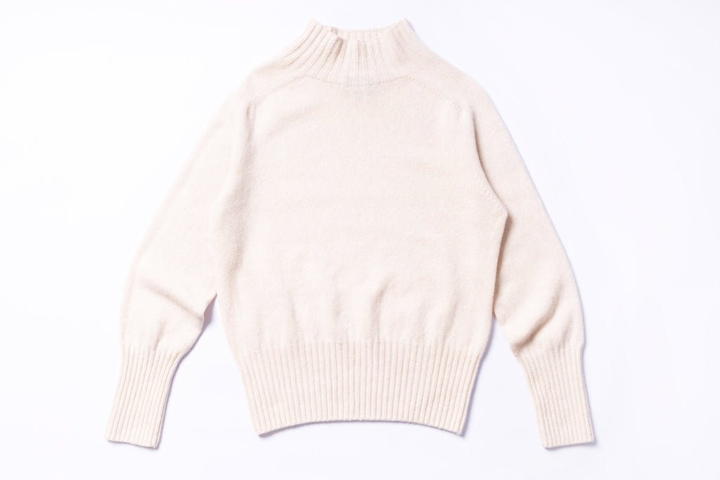 Beige sweater on a white background