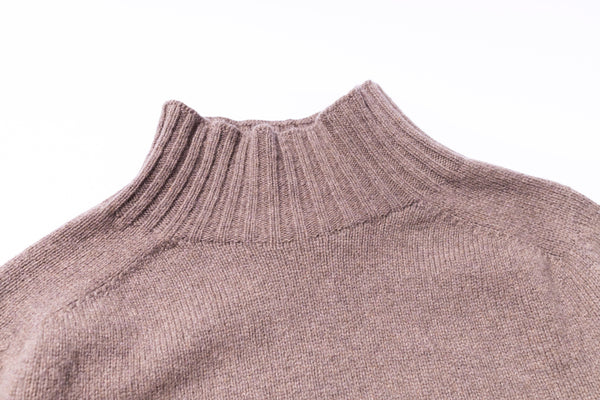 Close-up of a brown knitted sweater on a white background