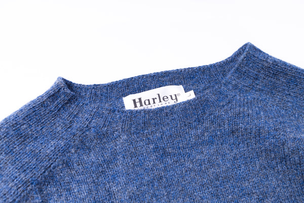 Blue sweater with a Harley label on a white background