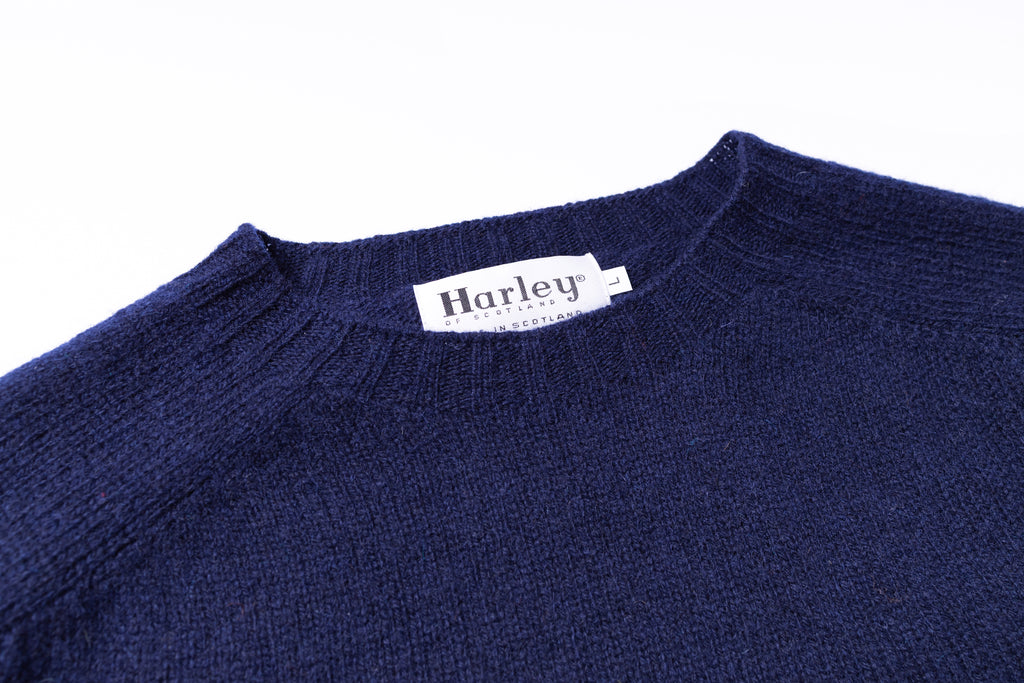 Navy blue sweater with a Harley label on a white background