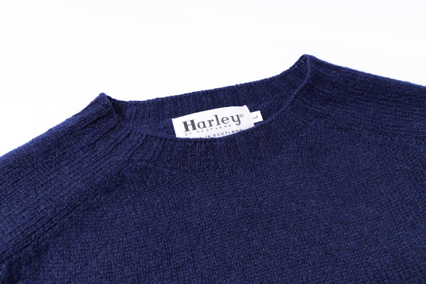 Navy blue sweater with a Harley label on a white background