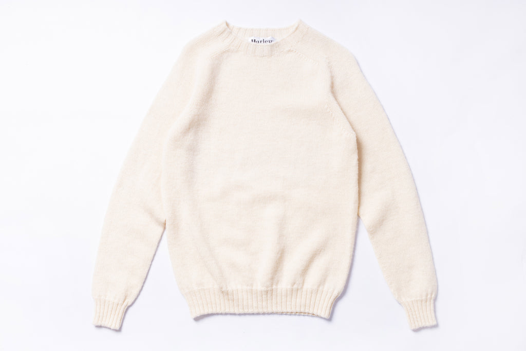 Cream-colored sweater on a white background