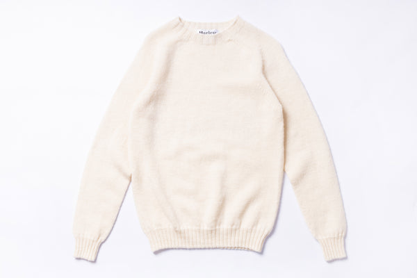Cream-colored sweater on a white background