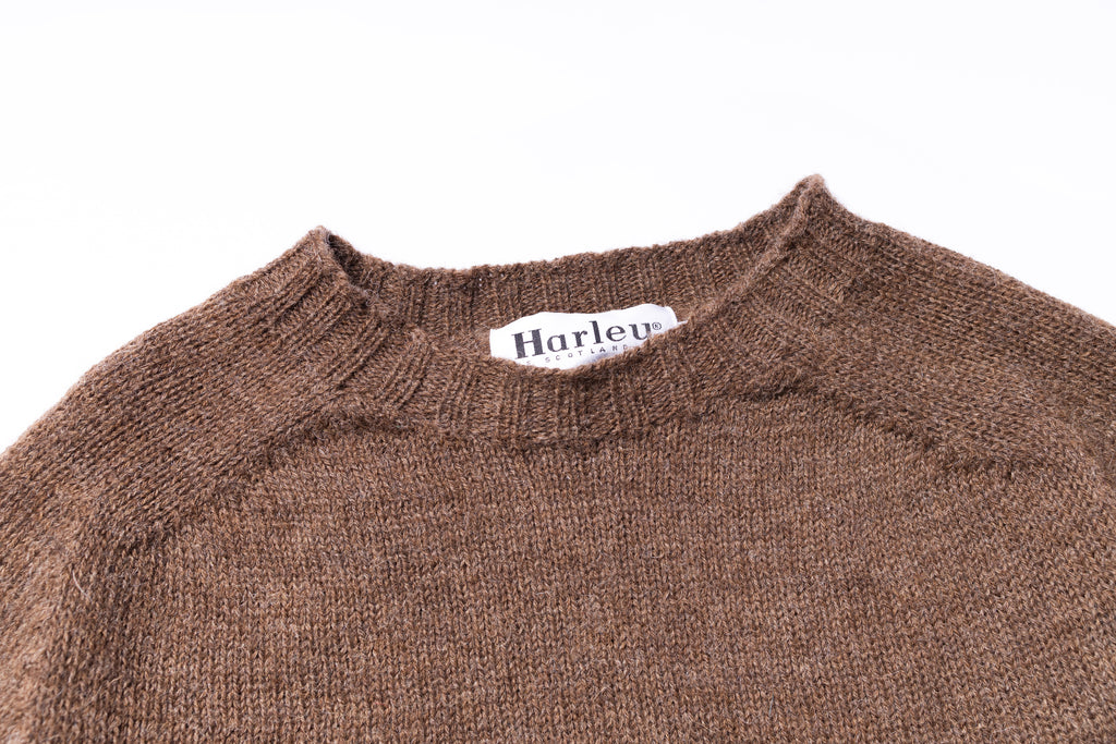 Brown sweater with 'Harley' brand label on a white background