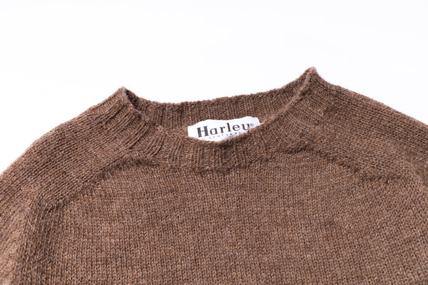 Brown sweater with 'Harley' brand label on a white background