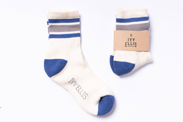 Pair of socks with blue accents and 'Ivy Ellis' branding on a white background