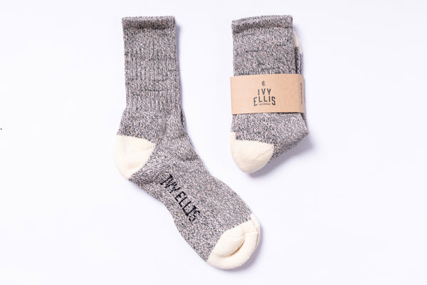 Pair of gray socks with white toes and heels, branded 'Ivy Ellis', on a white background.