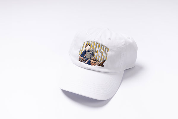 White cap with embroidered design on a white background