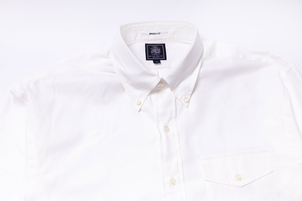 White dress shirt with a brand label on a white background