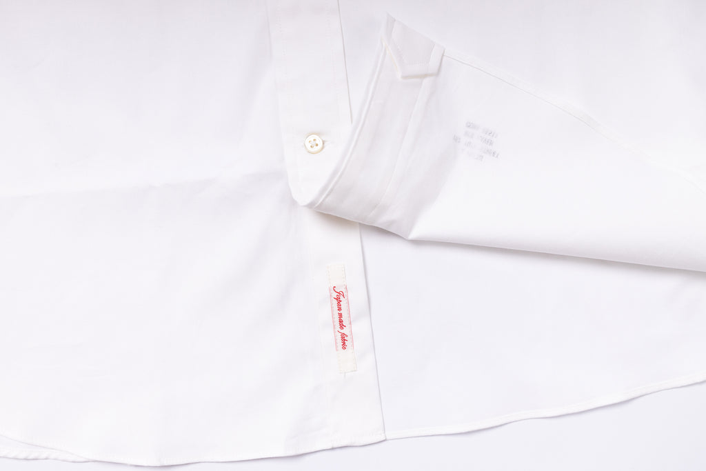 White shirt with a brand label on a white background